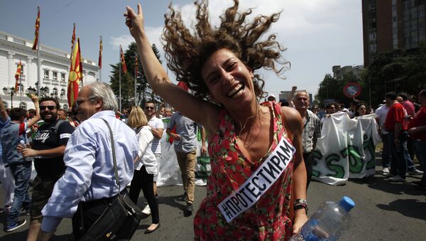 A woman dances while protesting in front of the Government building in Skopje, Macedonia - Sputnik International