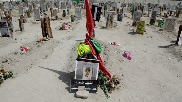 A sign on a child's grave reads: The happy martyr Haidar Jassam al-Maqaili, in memory of one of 21 victims of a May 22 mosque suicide bombing claimed by the Islamic State group in Qudeeh, Saudi Arabia, is seen on Saturday, May 30, 2015 - Sputnik International
