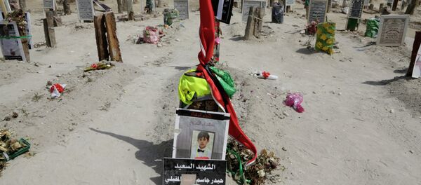 A sign on a child's grave reads: The happy martyr Haidar Jassam al-Maqaili, in memory of one of 21 victims of a May 22 mosque suicide bombing claimed by the Islamic State group in Qudeeh, Saudi Arabia, is seen on Saturday, May 30, 2015 A sign on a child's grave reads: The happy martyr Haidar Jassam al-Maqaili, in memory of one of 21 victims of a May 22 mosque suicide bombing claimed by the Islamic State group in Qudeeh, Saudi Arabia, is seen on Saturday, May 30, 2015 - Sputnik International