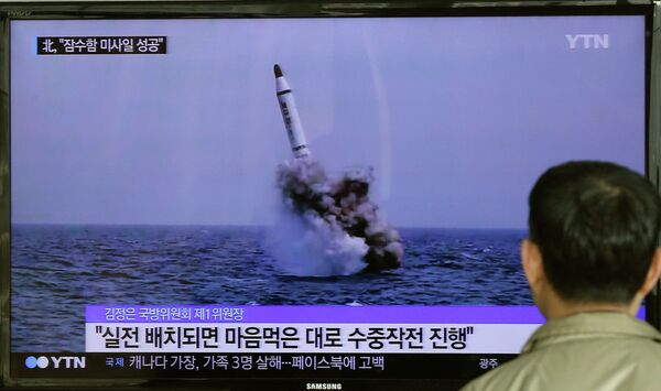 A South Korean man watches a TV news program showing an image published in North Korea's Rodong Sinmun newspaper of North Korea's ballistic missile believed to have been launched from underwater, at Seoul Railway station in Seoul, South Korea, Saturday, May 9, 2015 A South Korean man watches a TV news program showing an image published in North Korea's Rodong Sinmun newspaper of North Korea's ballistic missile believed to have been launched from underwater, at Seoul Railway station in Seoul, South Korea, Saturday, May 9, 2015 - Sputnik International