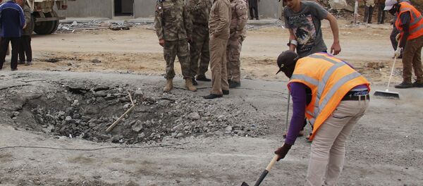 Workers clean the ground after a suicide car bomber blew himself up at a checkpoint in Dafniya outside Mistrata, Libya May 31, 2015 Workers clean the ground after a suicide car bomber blew himself up at a checkpoint in Dafniya outside Mistrata, Libya May 31, 2015 - Sputnik International
