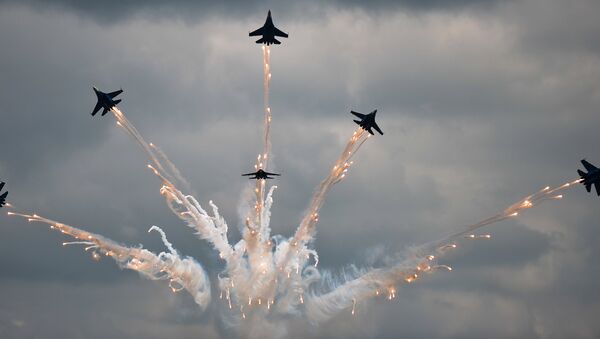 The Russkiye Vityazy (Russian Knights) aerobatic team performs in Sukhoi 27 jets at the Russian stage of the Aviadarts-2015 Flight Skills Competition in Voronezh - Sputnik International
