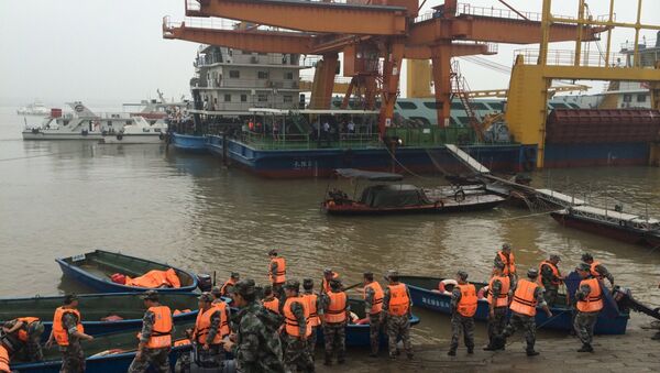 Rescue workers are seen near the site where a ship sank, in the Jianli section of the Yangtze River, Hubei province, China, June 2, 2015 - Sputnik International