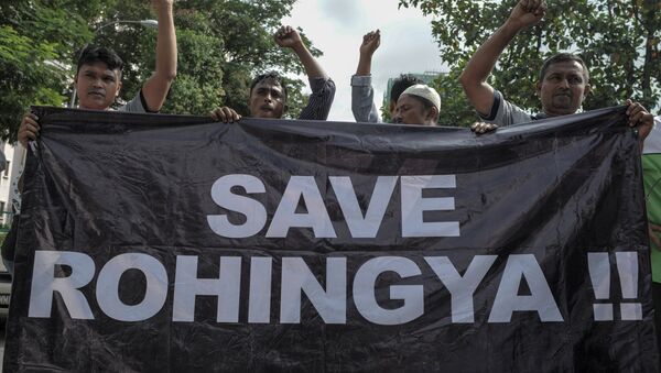 Ethnic Rohingya refugees from Myanmar residing in Malaysia hold a banner during a protest outside the Myanmar embassy in Kuala Lumpur on May 21, 2015 - Sputnik International