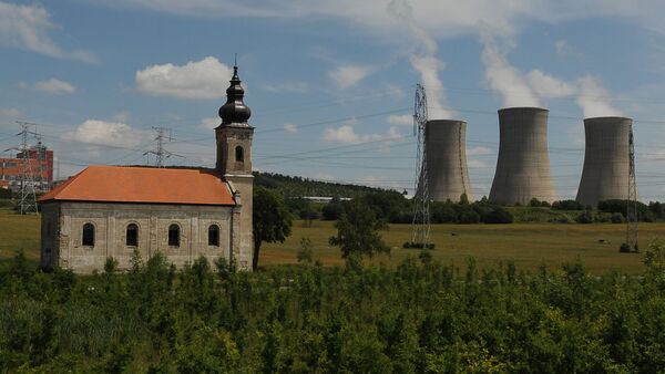 Steam cooling towers of the Mochovce nuclear power plant release steam behind a small church - Sputnik International