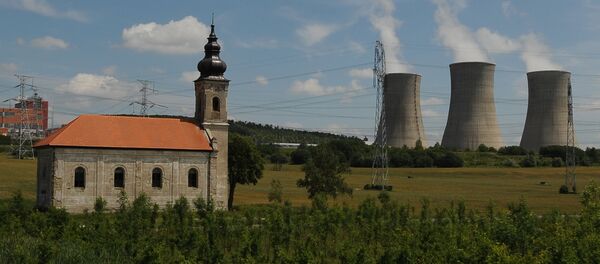 Steam cooling towers of the Mochovce nuclear power plant release steam behind a small church Steam cooling towers of the Mochovce nuclear power plant release steam behind a small church - Sputnik International