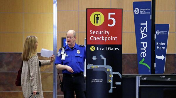 Passenger shows a boarding pass to a TSA agent at a security check-point at Seattle-Tacoma International Airport in SeaTac, Wash - Sputnik International