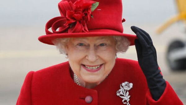 Britain's Queen Elizabeth II holds on to her hat in high winds as she arrives for a visit to RAF Valley, Anglesey, Wales, where her grandson Prince William, is stationed as a search and rescue helicopter pilot Friday April 1, 2011 - Sputnik International
