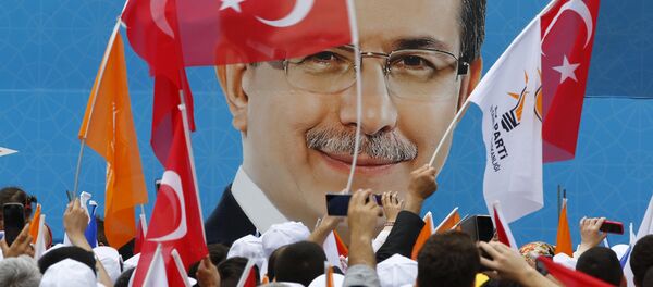 Supporters of the AK Party wave Turkish and party flags as they listen to Prime Minister Ahmet Davutoglu during an election rally for Turkey's June 7 parliamentary election in Istanbul, Turkey - Sputnik International