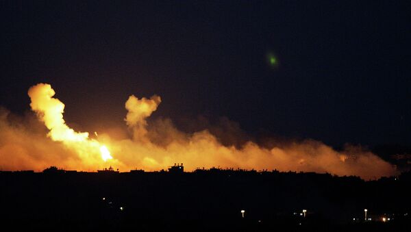 The sky is illuminated by explosions from Israeli military operations over the outskirts of Gaza City as seen from the Israel-Gaza Border. FILE PHOTO - Sputnik International