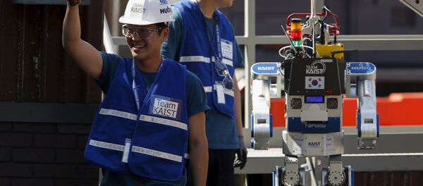 A member of Team KAIST DRC-Hubo celebrates after completing their run in the finals of the Defense Advanced Research Projects Agency (DARPA) Robotic Challenge in Pomona, California June 6, 2015. A member of Team KAIST DRC-Hubo celebrates after completing their run in the finals of the Defense Advanced Research Projects Agency (DARPA) Robotic Challenge in Pomona, California June 6, 2015. - Sputnik International