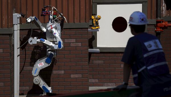 The Team KAIST DRC-Hubo robot completes the plug task before winning the finals of the Defense Advanced Research Projects Agency (DARPA) Robotic Challenge in Pomona, California June 6, 2015 - Sputnik International