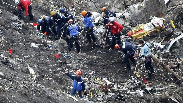 In this March 26, 2015 file photo, rescue workers work on debris of the Germanwings jet at the crash site near Seyne-les-Alpes, France - Sputnik International