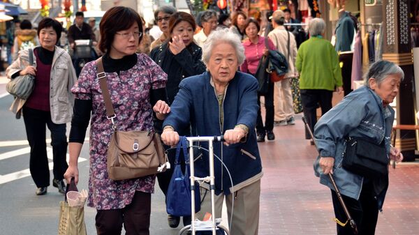 Elderly people stroll down a shopping precinct in Tokyo on October 28, 2011 - Sputnik International