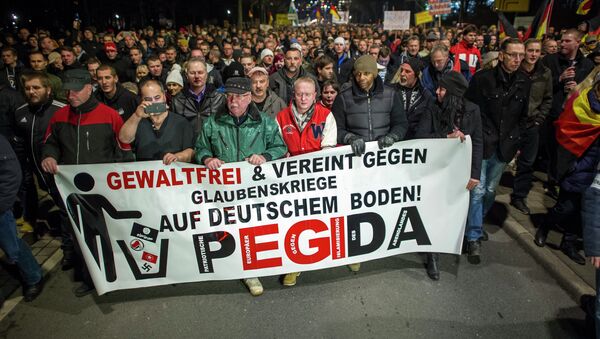 A picture taken on December 15, 2014 shows supporters of the PEGIDA movement, Patriotische Europaeer gegen die Islamisierung des Abendlandes, which translates to Patriotic Europeans Against the Islamification of the Occident, taking part in a rally in Dresden, eastern Germany. File photo - Sputnik International