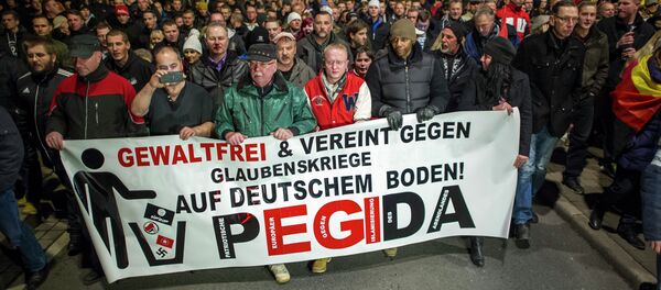 A picture taken on December 15, 2014 shows supporters of the PEGIDA movement, Patriotische Europaeer gegen die Islamisierung des Abendlandes, which translates to Patriotic Europeans Against the Islamification of the Occident, taking part in a rally in Dresden, eastern Germany. File photo A picture taken on December 15, 2014 shows supporters of the PEGIDA movement, Patriotische Europaeer gegen die Islamisierung des Abendlandes, which translates to Patriotic Europeans Against the Islamification of the Occident, taking part in a rally in Dresden, eastern Germany. File photo - Sputnik International
