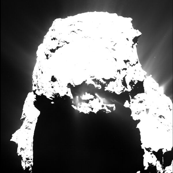 Comet 67P/Churyumov-Gerasimenko on 25 April 2015 from a distance of approximately 93 kilometres, seen through the narrow-angle OSIRIS camera on Rosetta. The image shows jets emanating from the comet’s small lobe after nightfall. - Sputnik International