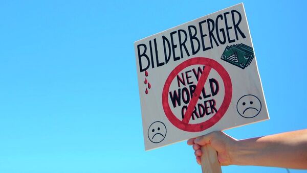 An activist protests near the meeting place for the conference of the Bilderberg Group - Sputnik International