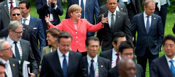 US President Barack Obama, center right, and German Chancellor Angela Merkel, center left, walk to a group photo of G-7 leaders. US President Barack Obama, center right, and German Chancellor Angela Merkel, center left, walk to a group photo of G-7 leaders. - Sputnik International
