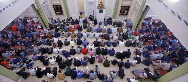 Muslim men sit on their prayer rug as visiting Imam Muhammad Adeyinka Mendes delivers his sermon before prayers in the mosque at the Islamic Society of Boston Cultural Center Friday, April 24, 2015, in Boston Muslim men sit on their prayer rug as visiting Imam Muhammad Adeyinka Mendes delivers his sermon before prayers in the mosque at the Islamic Society of Boston Cultural Center Friday, April 24, 2015, in Boston - Sputnik International
