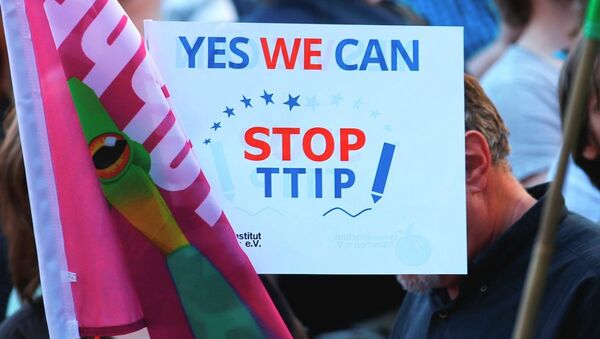 Demonstrators hold a sign against the TTIP contract during a protest - Sputnik International