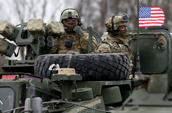 Members of US Army’s 2nd Cavalry Regiment ride on an armored vehicle - Sputnik International