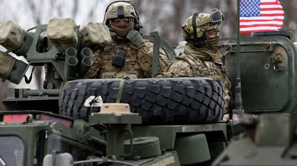 Members of US Army’s 2nd Cavalry Regiment ride on an armored vehicle - Sputnik International