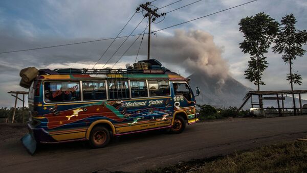 Общественный автобус проезжает мимо вулкана в районе Каро в провинции Северная Суматра  - Sputnik International