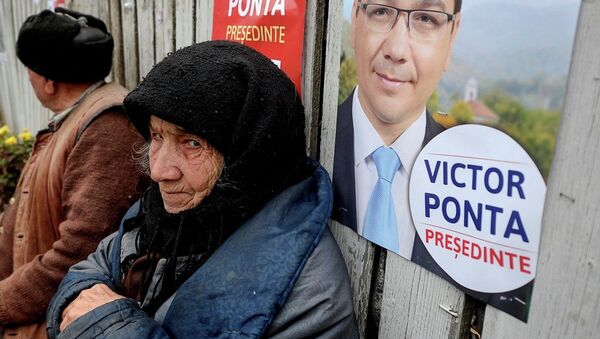 An elderly woman, back dropped by a campaign poster of Romanian Prime Minister Victor Ponta in 2011. - Sputnik International