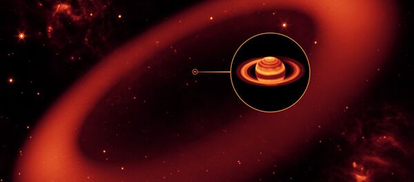 An artist’s illustration shows the grand scale of the Phoebe ring, with Saturn at its center. - Sputnik International