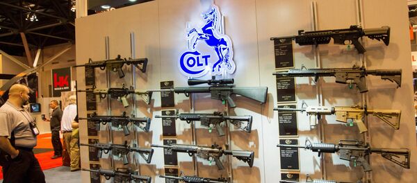 A wall of Colt M4 Carbines in various configurations are displayed at the National Rifle Association (NRA) Annual Meetings and Exhibits on April 14, 2012 in St. Louis, Missouri - Sputnik International