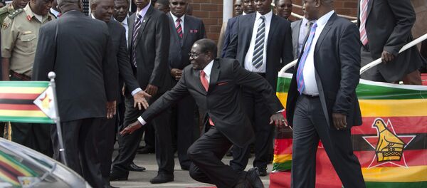 Zimbabwean President Robert Mugabe, center, falls after addressing supporters upon his return from an African Union meeting in Ethiopia, Wednesday, Feb. 4, 2015 Zimbabwean President Robert Mugabe, center, falls after addressing supporters upon his return from an African Union meeting in Ethiopia, Wednesday, Feb. 4, 2015 - Sputnik International