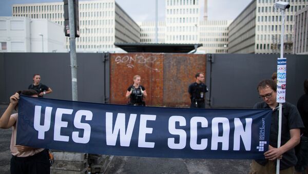 Demonstrators hold a banner during a protest against the supposed surveillance by the US National Security Agency, NSA, and the German intelligence agency, BND, during a rally in front of the construction site of the new headquarters of German intelligence agency in Berlin, Germany - Sputnik International