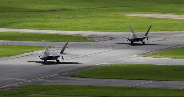 In this August 14, 2012 photo, two US Air Force F-22 Raptor stealth fighters taxi before take-off at Kadena Air Base on the southern island of Okinawa in Japan - Sputnik International