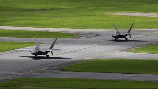 In this August 14, 2012 photo, two US Air Force F-22 Raptor stealth fighters taxi before take-off at Kadena Air Base on the southern island of Okinawa in Japan - Sputnik International