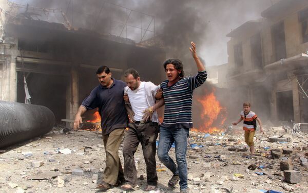 Syrian men help an injured person following a reported barrel bomb attack by Syrian government forces that hit an open market in the northern city of Aleppo, on June 3, 2015, killing and injuring people - Sputnik International