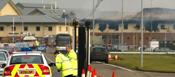A police car arrives as firemen controls the fire at Yarl's wood detention center. A police car arrives as firemen controls the fire at Yarl's wood detention center. - Sputnik International