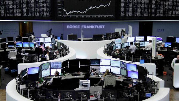 Traders work at their screens in front of the German share price index DAX board at the stock exchange in Frankfurt, Germany June 16, 2015 - Sputnik International