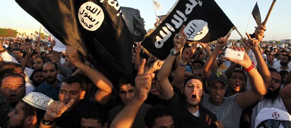 In this Sept. 21, 2012 file photo, Libyan followers of Ansar al-Shariah Brigades and other Islamic militias, hold a demonstration against a film and a cartoon denigrating the Prophet Muhammad in Benghazi, Libya - Sputnik International