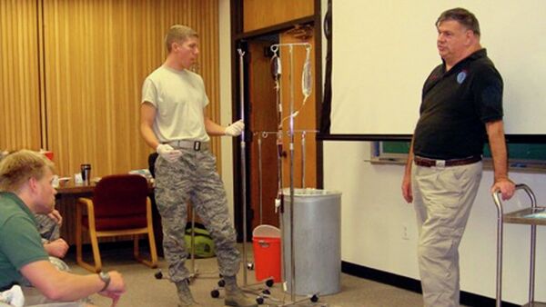 Dr. John Hagmann, right, teaches a course in treating battlefield trauma in this handout photograph taken around 2010 and released on June 17, 2015. - Sputnik International