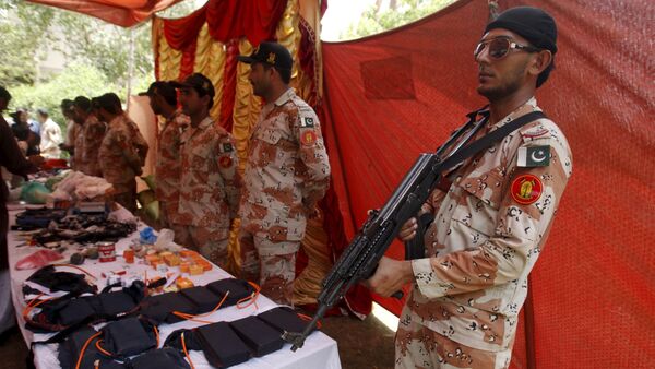 Paramilitary Soldiers display weapons and materials used in making bombs, seized during an operation, during a press briefing at Rangers Headquarter Karachi, Pakistan, May 26, 2015 - Sputnik International