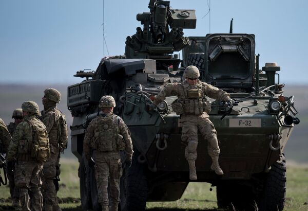 US Army serviceman jumps from armored vehicle during the NATO Wind Spring 15 military exercise at Smardan military shooting range on April 21, 2015 US Army serviceman jumps from armored vehicle during the NATO Wind Spring 15 military exercise at Smardan military shooting range on April 21, 2015 - Sputnik International