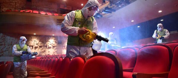 South Korean workers wearing protective gear fumigate a theater at the Sejong Culture Center in Seoul South Korean workers wearing protective gear fumigate a theater at the Sejong Culture Center in Seoul - Sputnik International