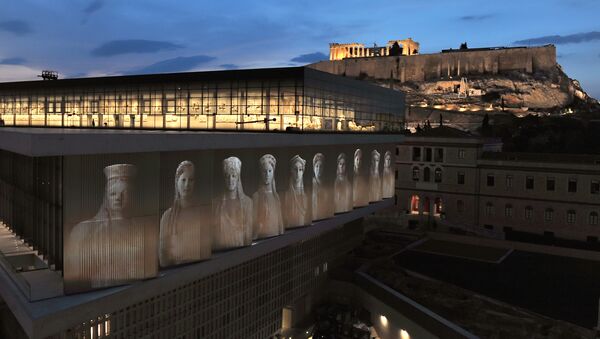 A projection depicting core-women statues is seen under the Parthenon hall on the new Acropolis museum building - Sputnik International