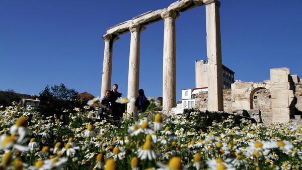Tourist walk among daisies and a part of the ancient building of Hadrian's Library near Monastiraki square, in Athens, Greece - Sputnik International