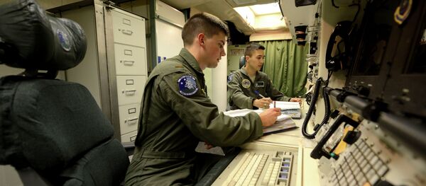 Oliver Parsons, left, and 1st Lt. Andy Parthum check systems in the underground control room where they work a 24-hour shift at an ICBM launch control facility near Minot. (File) - Sputnik International
