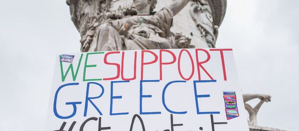 A man holds up a sign reading We support Greece #StopAusterity at the Republique Square during a demonstration against austerity in support of the Greek population in Paris, France, Saturday, June 20, 2015. A man holds up a sign reading We support Greece #StopAusterity at the Republique Square during a demonstration against austerity in support of the Greek population in Paris, France, Saturday, June 20, 2015. - Sputnik International
