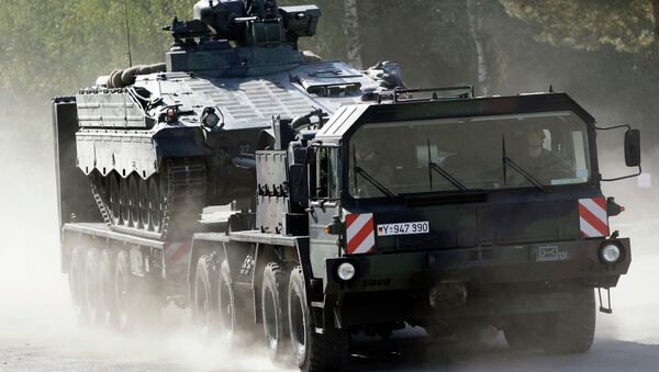 A transportation truck carries an armoured transport vehicle during a demonstration event held for the media by the German Bundeswehr. - Sputnik International