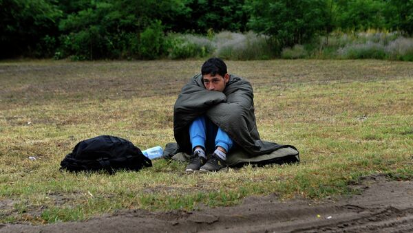An Afghan refugee rests on the Hungarian Serbian border area near Asotthalom, Hungary. - Sputnik International