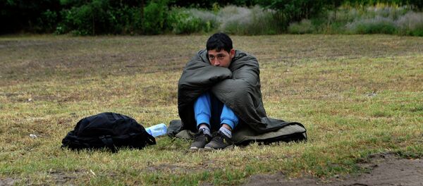 An Afghan refugee rests on the Hungarian Serbian border area near Asotthalom, Hungary. An Afghan refugee rests on the Hungarian Serbian border area near Asotthalom, Hungary. - Sputnik International
